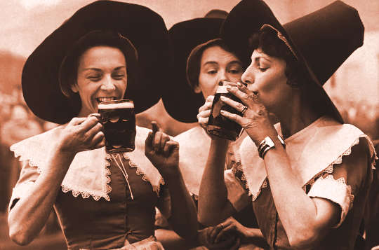 Three women dressed in Middle-Age period garb as alewives