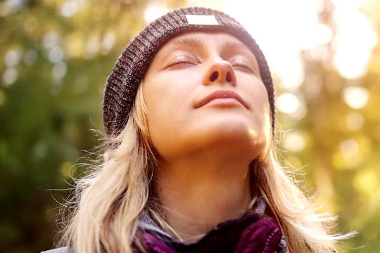 woman with eyes closed face up to the sky