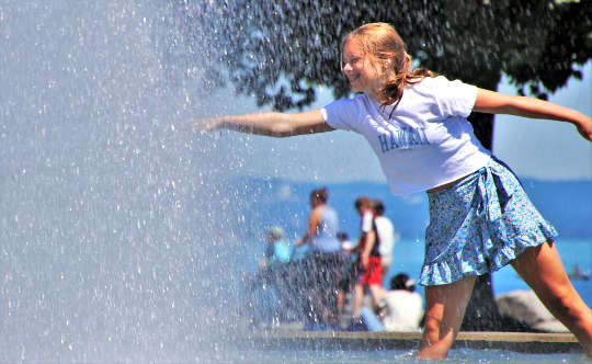 a girl in a water fountain