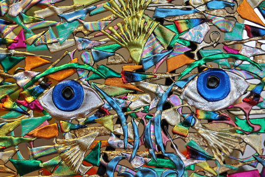 abstract artwork of a face with two blue saucer eyes