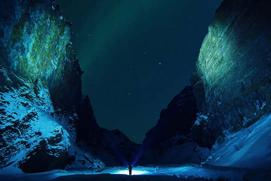 aurora borealis seen from a canyon in Iceland