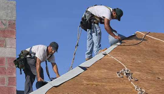 two men working on a roof