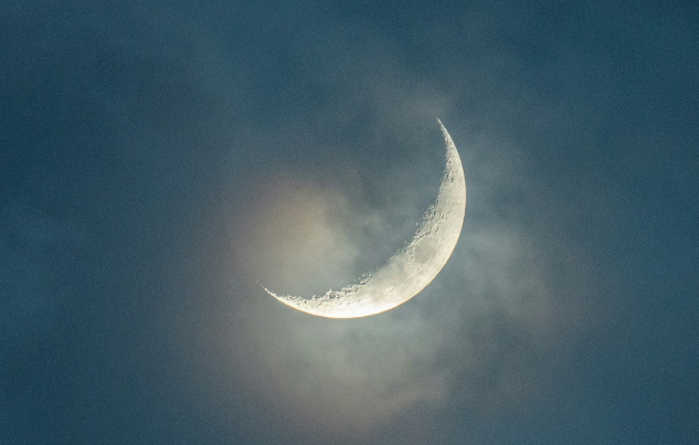 crescent moon seen through the clouds