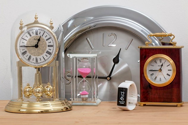 various clocks and watches all showing 15 minutes to 1