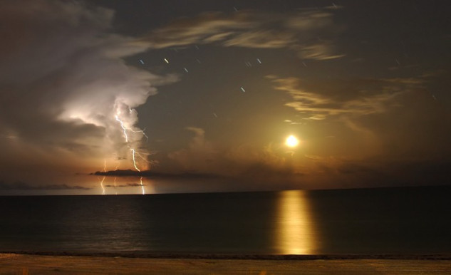 moon setting over the Gulf of Mexico illuminating clouds, sky, and water