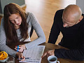 Mother organizing household tasks while managing cognitive labor, illustrating the hidden burden that impacts her mental health.