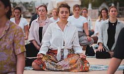 a group of women sitting together and meditating