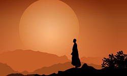 a monk standing peaceful in front of the setting sun