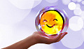 a hand holding a round smiling face image