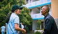 a young person speaking with an elderly man