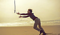 a man on a beach playing with a sword