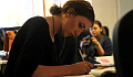 young woman sitting at a desk in deep concentration