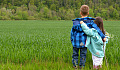 two children, brother and sister, with arms around each other