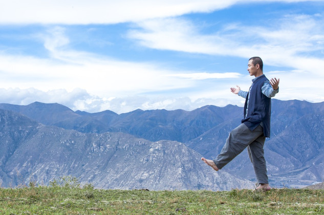 a man walking with arms wide open in a balanced pose