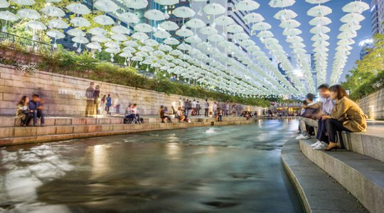 The seven-mile Cheonggyecheon Stream runs through downtown Seoul, South Korea. The stream had at one time been covered over by roads and eventually an elevated highway. In 2005 it was uncovered and turned into a popular public square. Photo by Adzrin Mansor.