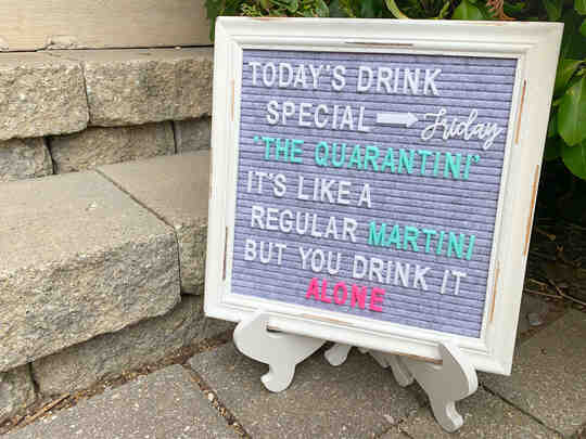 Sign that reads 'today's drink special is the quarantini, its like a regular martini but you drink it alone'