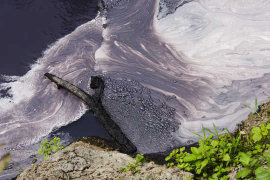 Textile factory waste drains into a tributary of the Citarum River outside Bandung, Java, Indonesia, 2018.