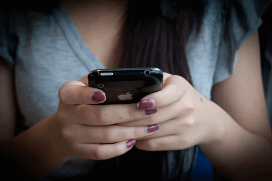 a woman texting on her phone