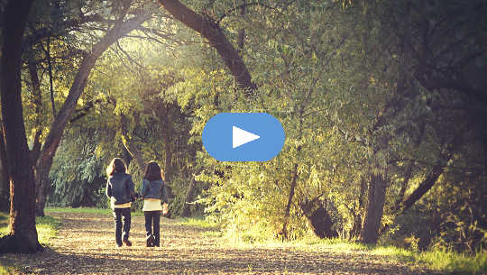 two girls walking on a path