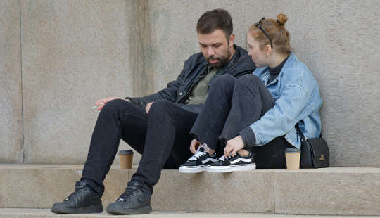 couple having a conversation sitting outside on steps