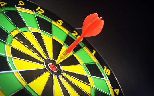 a dart right in the bull's eye of a dartboard