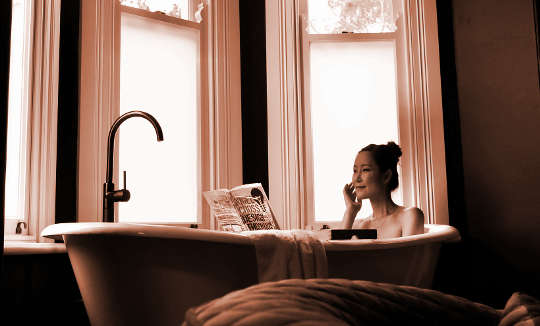 woman soaking in a bathtub