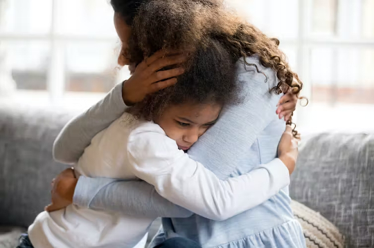 mother hugging child