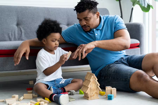 a man talking and playing with his son