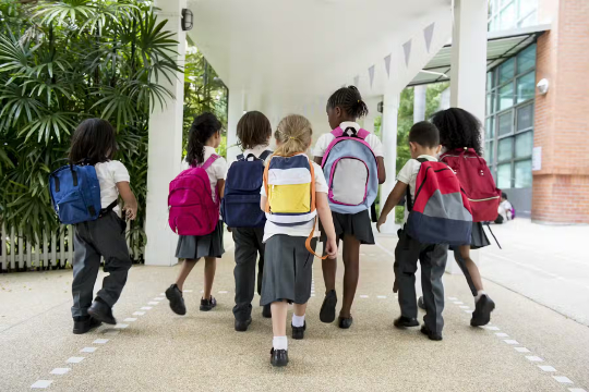 a group of young children walking to school