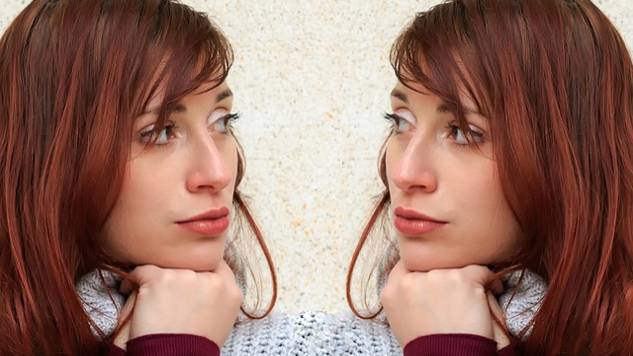 the face of a woman staring at her reflection