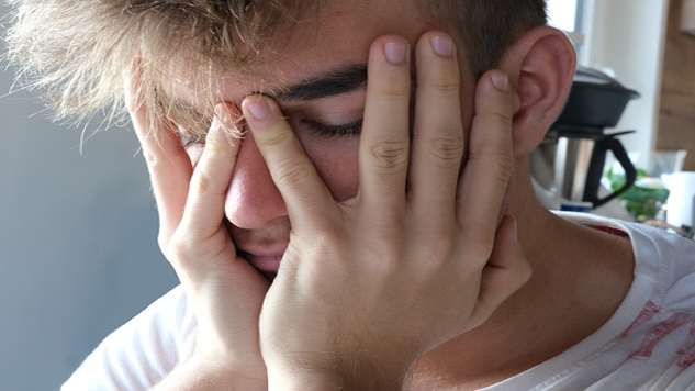 man with his head resting in his hands