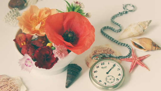 a hibiscus flower and a pocket watch