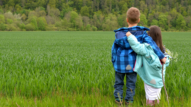 two children, brother and sister, with arms around each other