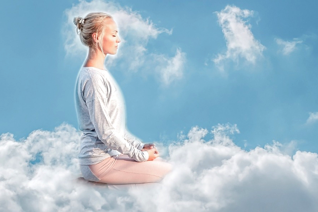 woman sitting on a cloud meditating