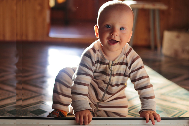 a young boy, smiling with eyes wide open and radiant