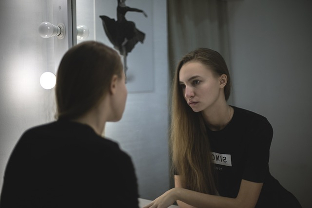 woman looking at herself in a mirror