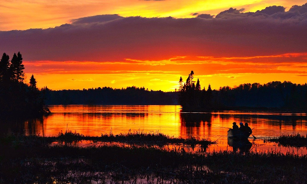 dawn breaking over a lake