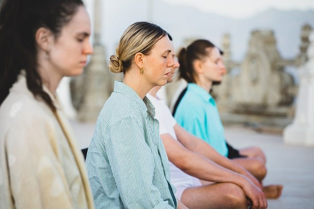 women sitting in meditation