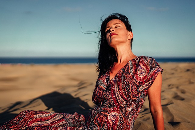 smiling woman with eyes closed with her face turned up to the sun