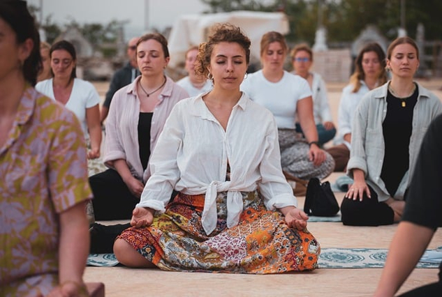 women sitting in meditation