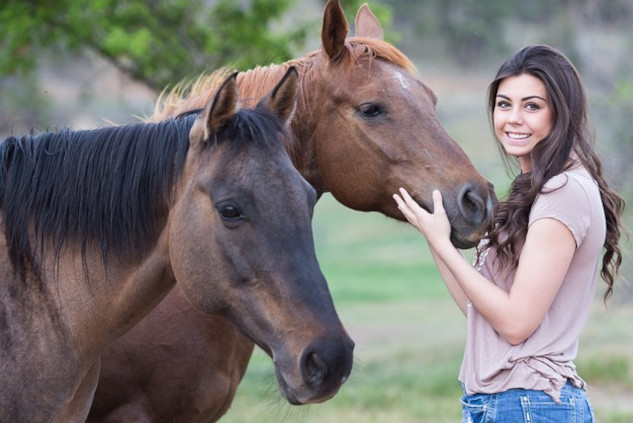 a young woman with two horses