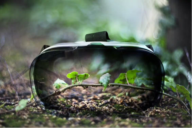 A VR headset with sprouting green leaves reflected on its surface represents the debate on whether virtual nature can provide the same wellness benefits as real nature.