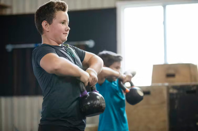 Children and teens engaged in strength training.