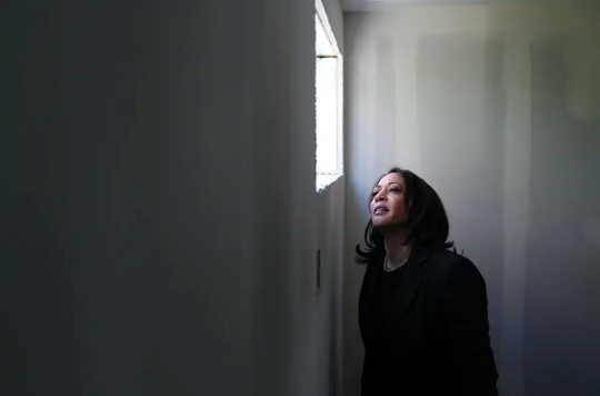 Senator Kamala Harris peers out of a window at Veterans Village in Las Vegas.