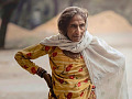 an older woman standing outside with a very determined expression