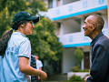 a young person speaking with an elderly man