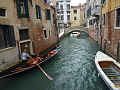 a gondola and other boats on a canal in Venice, Italy