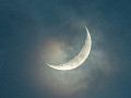crescent moon seen through the clouds