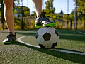 someone's foot on top of a soccer ball