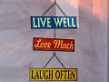 a sign that says: Live Well, Love Much, Laugh Often